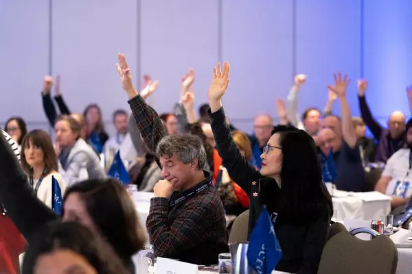 AMAPCEO members raising their hands to vote on a motion