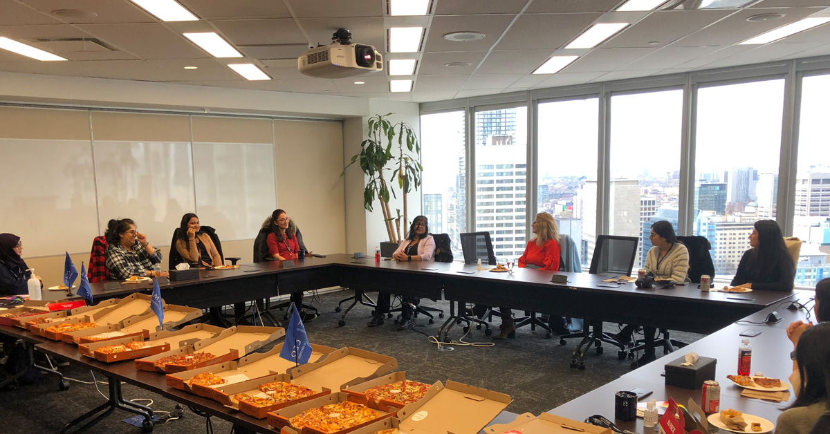 Women’s Caucus members connecting at a networking event at the AMAPCEO office