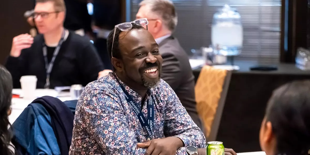 Smiling member at an AMAPCEO event