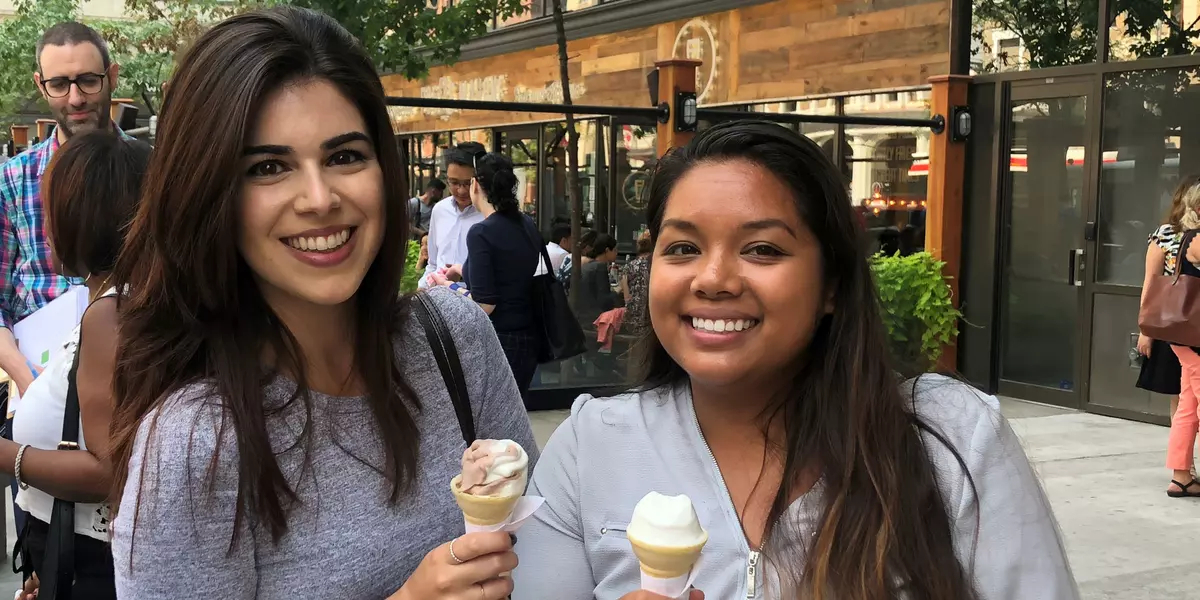 Two smiling members having ice cream at an AMAPCEO social event