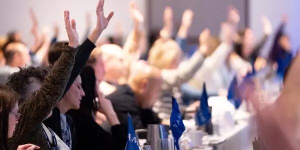 A group of AMAPCEO members raising their hands to vote