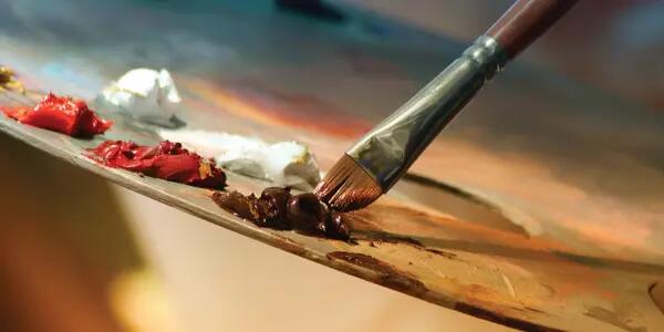 A painter's brush against a palette