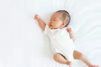 A newborn baby with its fist raised in solidarity