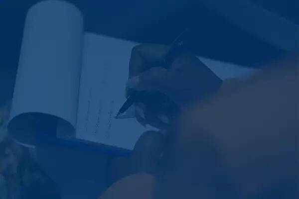 A person writing on a clipboard
