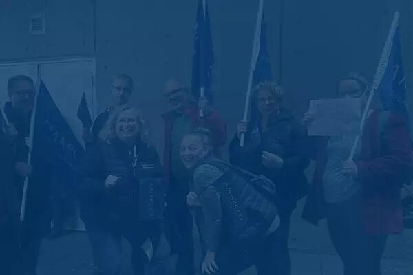 A group of AMAPCEO members holding flags and signs