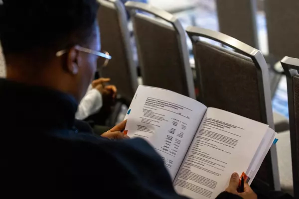 A Delegate reviewing a copy of the AMAPCEO operating budget