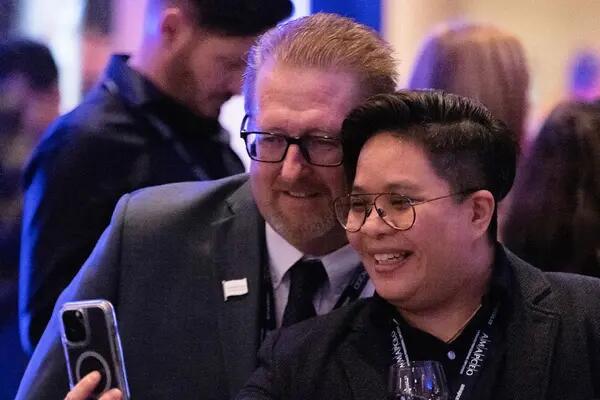AMAPCEO President Dave Bulmer joins a member for a selfie at a union reception