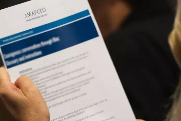 a person holding an AMAPCEO document