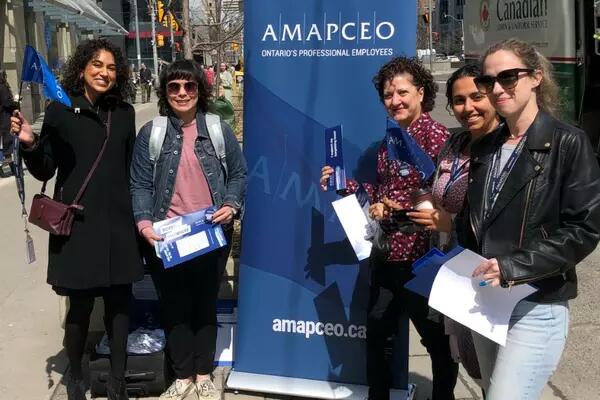 Photo of AMAPCEO members showing off their union swag