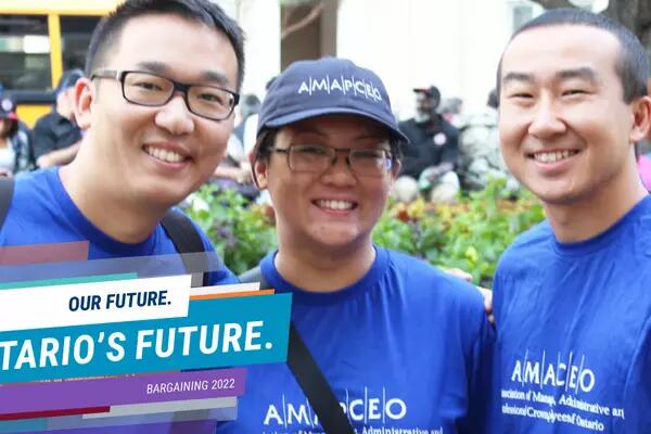 Photo of smiling AMAPCEO members wearing navy