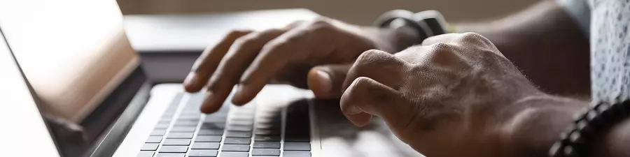 Image of hands on a laptop