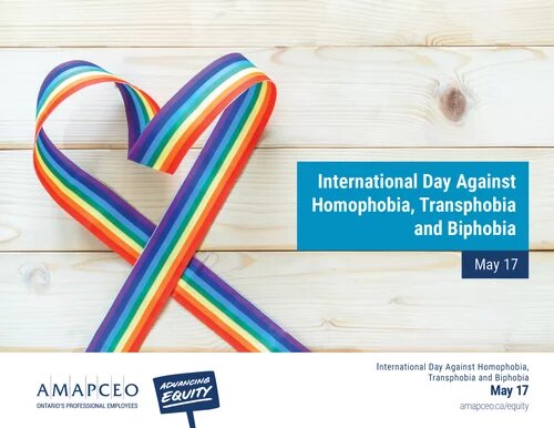 Image of a rainbow ribbon placed on a wooden deck to represent International Day Against Homophobia, Transphobia and Biphobia