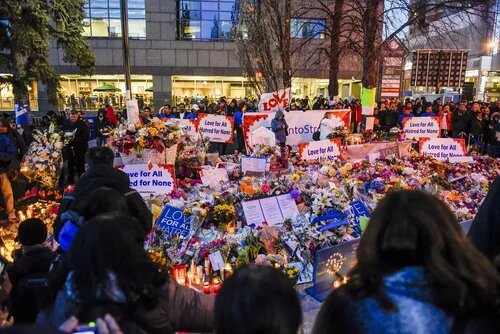 Crowd gathered at Toronto Strong vigil with signs and flowers