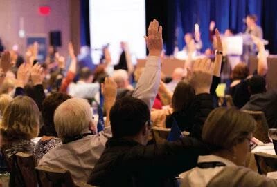 AMAPCEO members raising their hands at ADC Conference