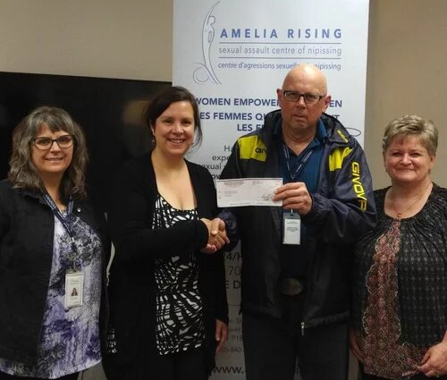 AMAPCEO members handing a cheque to volunteer group Amelia Rising