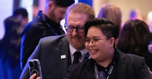 AMAPCEO President Dave Bulmer joins a member for a selfie at a union reception
