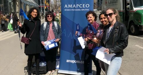 Photo of AMAPCEO members showing off their union swag