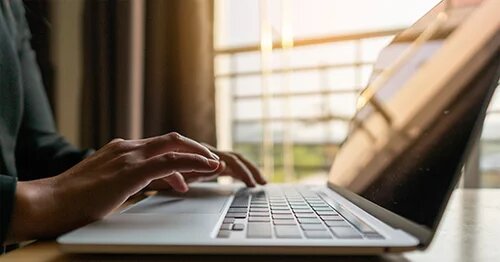 Image of hands on laptop