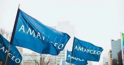 Four AMAPCEO flags waving in wind
