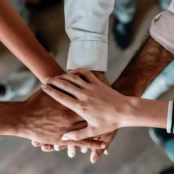 Image of hands in a group together celebrating team work