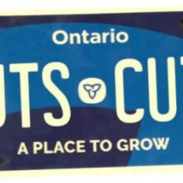 A dark blue Ontario license plate with the words "CUTS CUTS" in lieu of a license plate number 