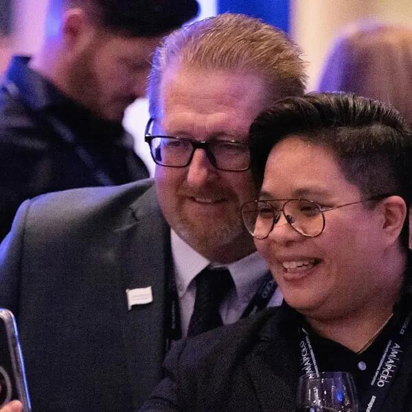 AMAPCEO President Dave Bulmer joins a member for a selfie at a union reception