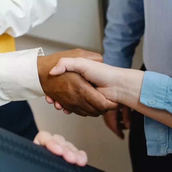People dressed in business attire shaking hands
