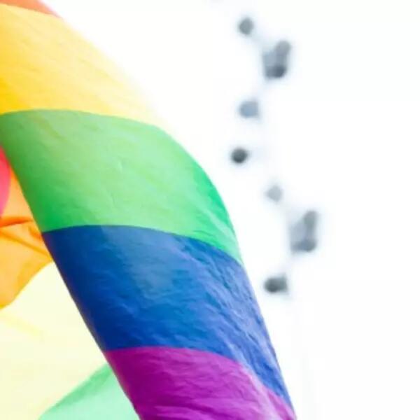 A Pride flag waving in the wind