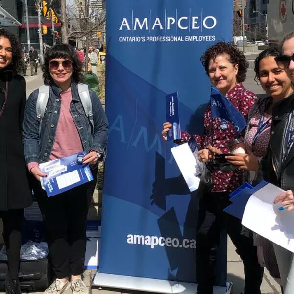Photo of AMAPCEO members showing off their union swag