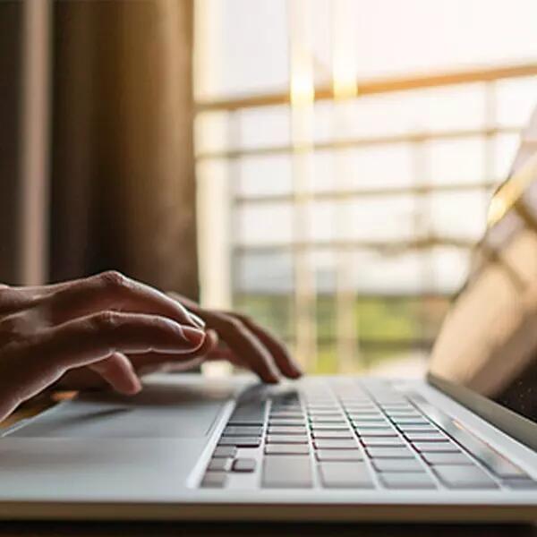 Image of hands on laptop