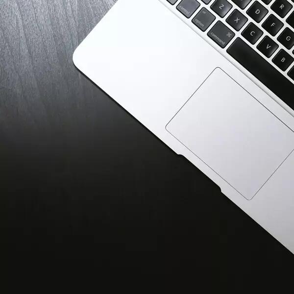 Image of laptop under a spotlight